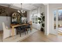 Elegant dining room featuring a wood table, chandelier, and access to backyard at 7175 Linden Dr, South Fulton, GA 30349