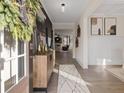 Bright entryway with hardwood floors, decorative console table, and view to living room at 7175 Linden Dr, South Fulton, GA 30349