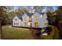 Luxury home with large backyard and driveway, surrounded by trees at 1731 N Springs Dr, Dunwoody, GA 30338