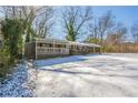 Ranch house with covered porch, carport, and snow covered yard at 190 Highland Blvd, Stockbridge, GA 30281