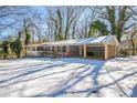 Brick ranch house with carport and snow-covered yard at 190 Highland Blvd, Stockbridge, GA 30281