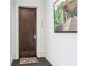 Apartment entry with wood door and art at 230 Vickery Falls Dr, Roswell, GA 30075
