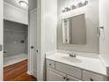 Bright bathroom with white vanity, updated fixtures, and tile flooring leading to a walk-in closet at 1019 Braelin Ct, Woodstock, GA 30189