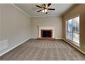 Living room featuring a brick fireplace and neutral carpeting at 1019 Braelin Ct, Woodstock, GA 30189