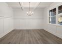 Spacious dining room with chandelier and wainscoting at 7179 Linden Dr, South Fulton, GA 30349