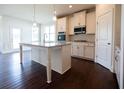 Spacious kitchen with an island, stainless steel appliances, and hardwood floors at 7179 Linden Dr, South Fulton, GA 30349