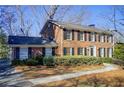 Two-story brick home with landscaping and walkway at 882 Edgewater Trl, Atlanta, GA 30328