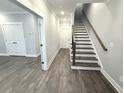 Bright hallway with wood-look flooring, leading to stairs and rooms at 1031 Robert Smalls Way, Atlanta, GA 30318