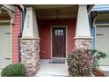 Inviting front entrance with a dark wood door and stone pillars at 4116 Mars Bay # 27, Acworth, GA 30101