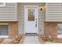 Front door entry, showing a white door and brick accents at 900 Sage Nw Ln, Conyers, GA 30012