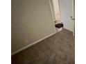 Small carpeted bedroom with neutral walls and a door at 1876 Selwyn Dr, Decatur, GA 30035