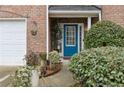 Charming entryway featuring a bright blue front door and lush landscaping at 245 Fern Crest Dr, Lawrenceville, GA 30046