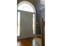 Front entry with hardwood floors and an arched window at 608 Morgans Trce, Ellenwood, GA 30294