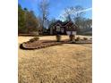 Landscaped yard with brick border and a view of the house at 608 Morgans Trce, Ellenwood, GA 30294