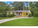 Ranch house with yellow siding, brick accents, and a carport at 2907 Renfro Nw Dr, Atlanta, GA 30318