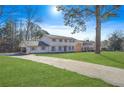 Two-story house with driveway and landscaping, showcasing curb appeal at 3970 Somerled Trl, Atlanta, GA 30349