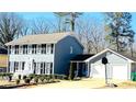 Two-story house with gray siding, shutters, and a two-car garage at 501 Fond Du Lac Dr, Stone Mountain, GA 30088