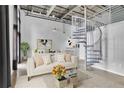 Modern living room with spiral staircase and neutral color palette at 572 Edgewood Ne Ave # 309, Atlanta, GA 30312