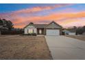 Ranch style home with stone accents, two-car garage, and landscaped yard at 7 Little Creek Manor Dr, Dallas, GA 30157