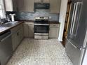 Modern kitchen with gray cabinets, wood countertops, and patterned floor at 3973 Woodland Se Cir, Conyers, GA 30013