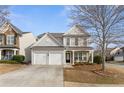 Traditional two-story home with attached two-car garage and covered front porch at 702 Berkeley Ter, Canton, GA 30115