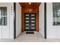 Stylish black double front door with wood accent wall at 1416 Elizabeth Sw Ave, Atlanta, GA 30310