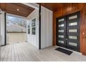 Modern front porch with wood ceiling and black double door at 1416 Elizabeth Sw Ave, Atlanta, GA 30310