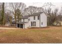 Two-story house with white siding, black trim, and a two-car garage at 684 Tarkington Rd, Stone Mountain, GA 30088