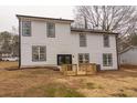 Rear view of a white two-story house with a deck at 684 Tarkington Rd, Stone Mountain, GA 30088