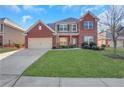 Brick two-story house with a large front yard and attached garage at 1209 Westgate Dr, Lilburn, GA 30047