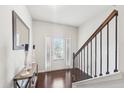 Bright entryway with hardwood floors, console table, and staircase at 102 Freedom Dr, Acworth, GA 30102