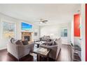 Inviting living room with stone fireplace, ceiling fan, and abundant natural light at 102 Freedom Dr, Acworth, GA 30102