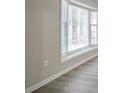 Bright living room featuring a bay window and wood-look floors at 2026 Morris Dr, Riverdale, GA 30296