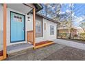 Front entry with teal door and wood accents at 3460 Fairlane Dr, Atlanta, GA 30331