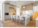 Modern kitchen with light wood cabinets, white countertops, and island with seating at 5180 Howard Rd, Cumming, GA 30040