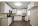 Modern kitchen with stainless steel appliances, granite countertops, and white cabinetry at 3002 Arabian Woods Dr, Lithonia, GA 30038