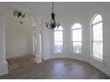 Bright dining room featuring wood flooring, arched windows, decorative wainscoting, and chandelier at 4259 Creek Haven Dr, Marietta, GA 30062