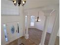 Grand two-story foyer with decorative tile flooring, ornate columns, and elegant chandeliers at 4259 Creek Haven Dr, Marietta, GA 30062