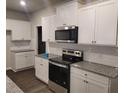 Kitchen with white cabinets, granite countertops, and stainless steel appliances at 6615 Bluffview Dr, Douglasville, GA 30134