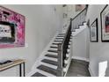 Modern staircase with dark wood treads and black spindles at 6770 Cadence Blvd, Atlanta, GA 30328