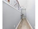 Bright hallway with wood-look floors and modern staircase at 4194 Integrity Way, Powder Springs, GA 30127