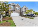 Townhome exterior with gray siding, white garage door, and landscaping at 1267 Sunny Lake Dr, Lawrenceville, GA 30043