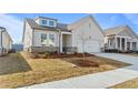 New home with a well-manicured lawn, showing the side entry garage and covered entryway at 1682 Juniper Berry Way, Loganville, GA 30052