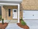 White front door with sidelights and a covered porch at 1862 Weatherbrook Cir, Lawrenceville, GA 30043