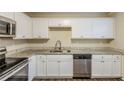 Renovated kitchen with white cabinets, granite countertops, and stainless steel appliances at 3164 Delmar Nw Ln, Atlanta, GA 30311