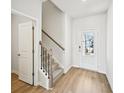 Bright entryway with wood-look floors, stairs with carpet runner, and white front door at 4178 Waratah Way, Mableton, GA 30126