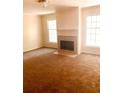 Spacious living room featuring a fireplace and large windows at 79 Place Fontaine, Lithonia, GA 30038