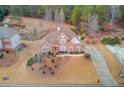 Brick home with driveway and surrounding trees at 3640 Rolling Creek Dr, Buford, GA 30519