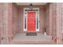 Red front door entryway with brick columns at 3640 Rolling Creek Dr, Buford, GA 30519