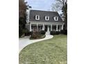 Two-story house with white exterior, front porch, and landscaped lawn at 975 Seaboard Nw Ave, Atlanta, GA 30318